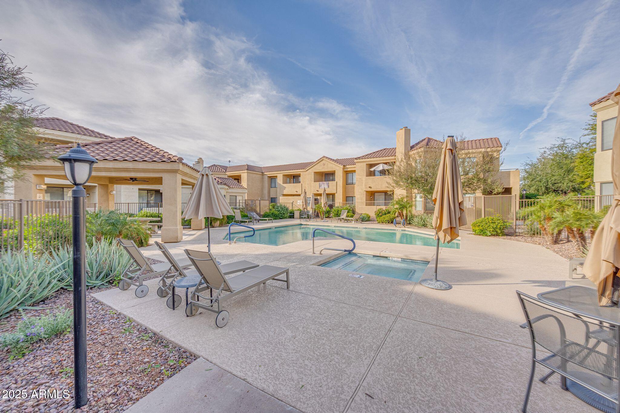 7575 East Indian Bend Road, Unit 2085 Scottsdale, AZ 85250 - Photo 22 of 30 a view of a house with a swimming pool and sitting area