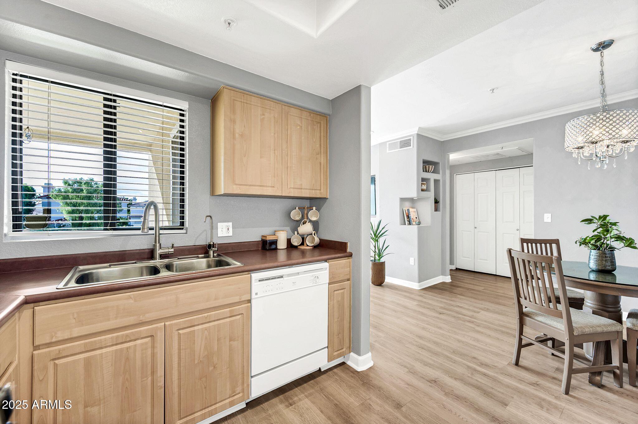 7575 East Indian Bend Road, Unit 2085 Scottsdale, AZ 85250 - Photo 8 of 30 a kitchen with a sink stove and cabinets