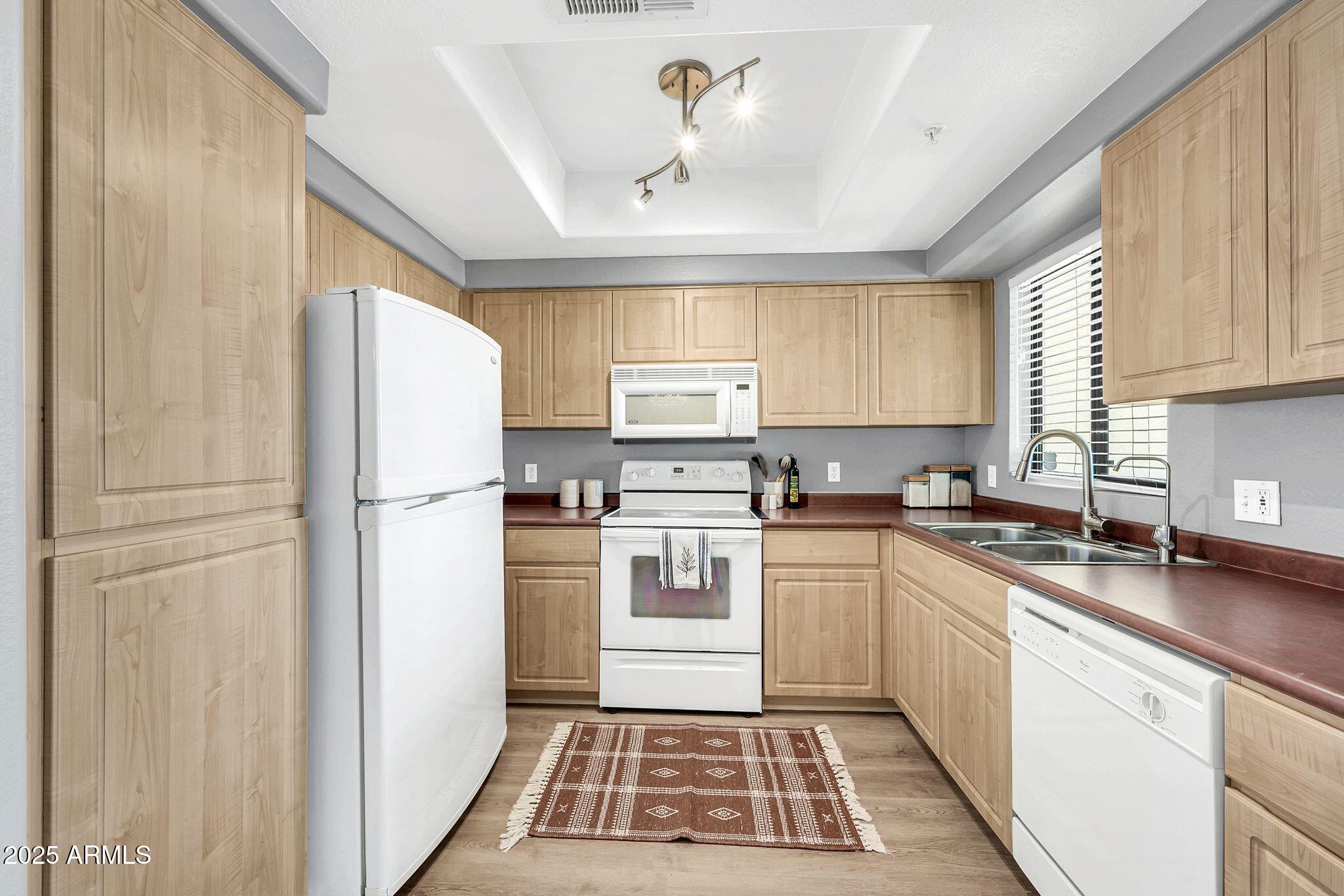 7575 East Indian Bend Road, Unit 2085 Scottsdale, AZ 85250 - Photo 9 of 30 a kitchen with a refrigerator sink and cabinets