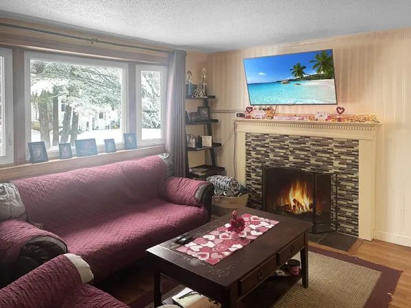 a living room with furniture a table and a fireplace