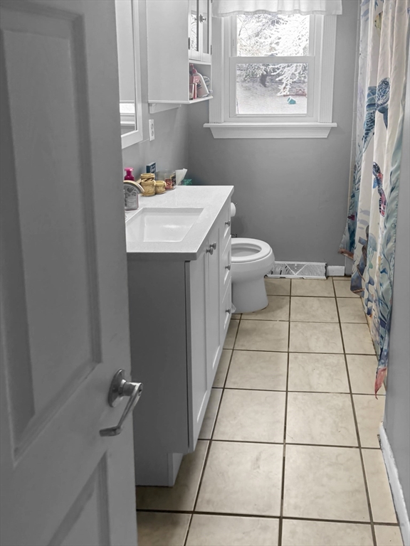 60 Wethersfield Road Bellingham, MA 02019 - Photo 4 of 7 a bathroom with a sink a toilet and a mirror