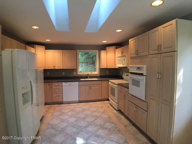 567 Snow Hill Road Cresco, PA 18326 - Photo 2 of 17 a kitchen with a refrigerator and a stove top oven
