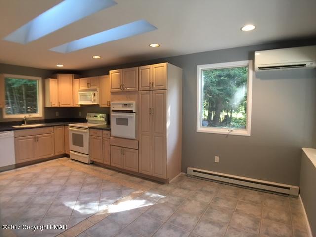 567 Snow Hill Road Cresco, PA 18326 - Photo 4 of 17 a kitchen with white cabinets and appliances