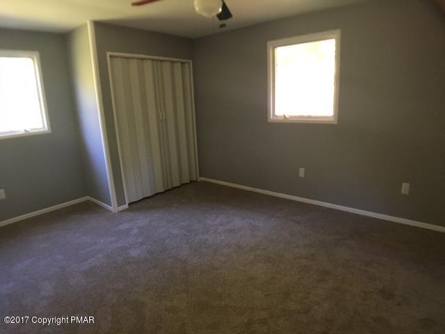 567 Snow Hill Road Cresco, PA 18326 - Photo 6 of 17 an empty room with windows