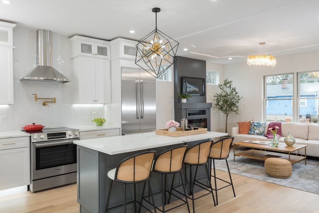 a kitchen with a table chairs stove and cabinets