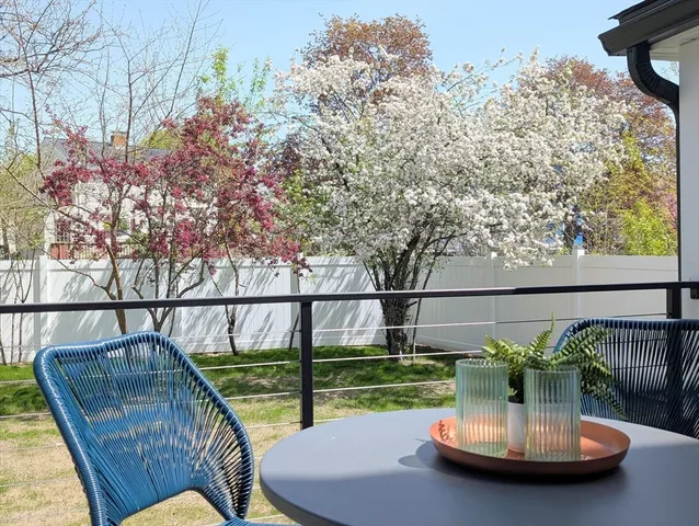 a view of a balcony with two chairs