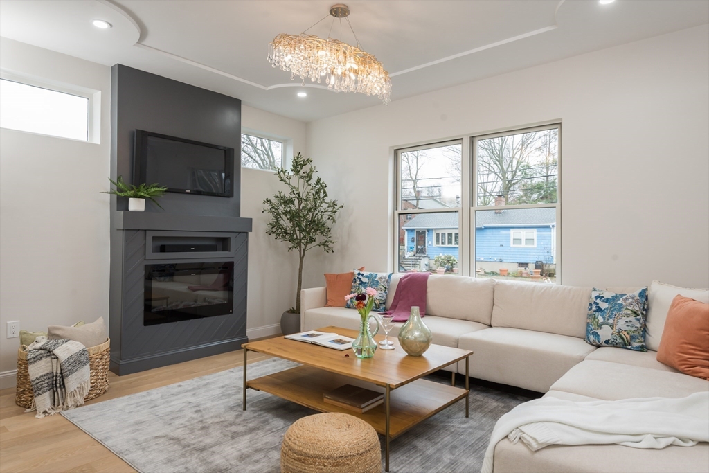 6 Gordon Road Arlington, MA 02474 - Photo 2 of 40 a living room with furniture a large window and a fireplace