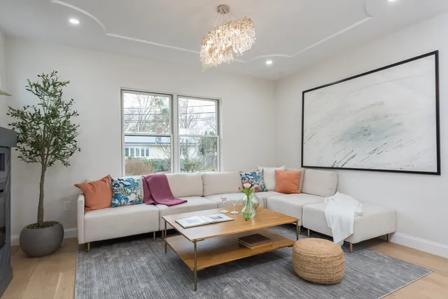 a living room with furniture and a potted plant