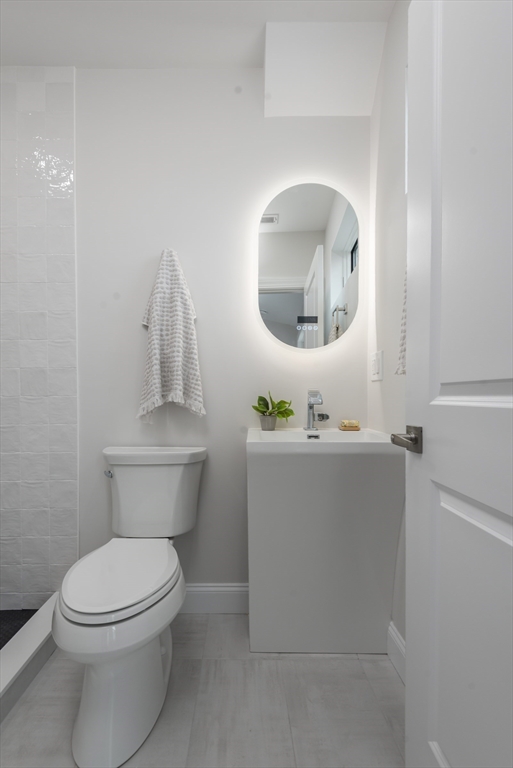 6 Gordon Road Arlington, MA 02474 - Photo 33 of 40 a bathroom with a toilet a sink and mirror