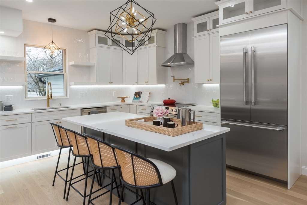 6 Gordon Road Arlington, MA 02474 - Photo 5 of 40 a kitchen with a table and chairs in it