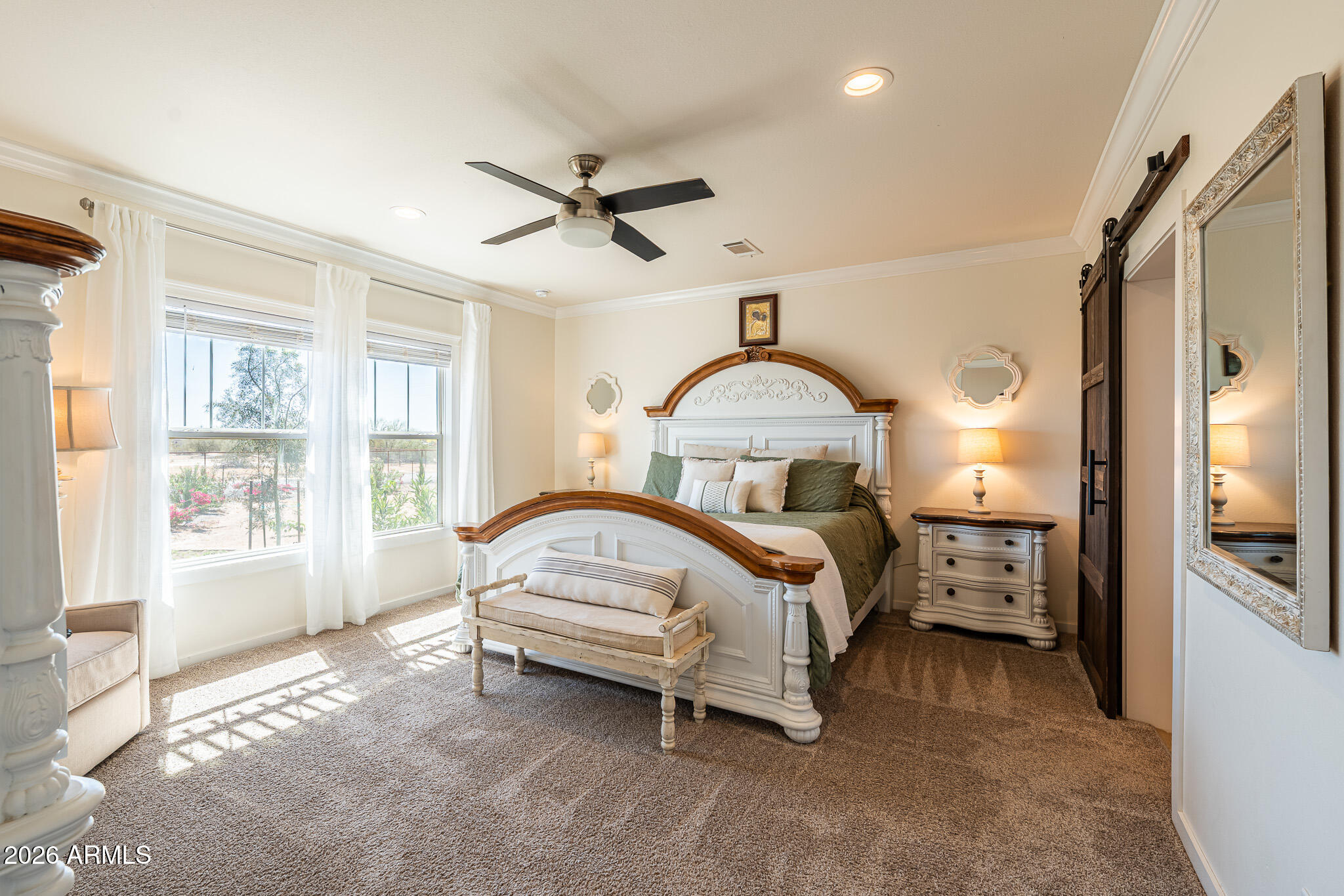 a bedroom with a bed couch and a window