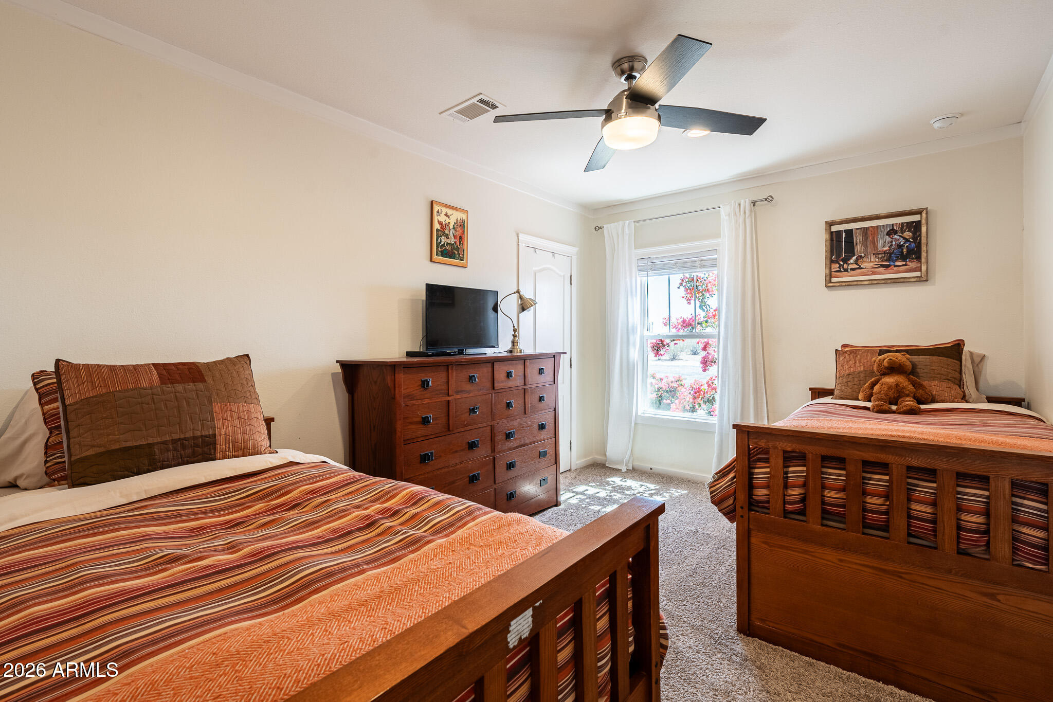 22622 East Day Spring Lane Florence, AZ 85132 - Photo 20 of 70 a bedroom with a bed and a chandelier