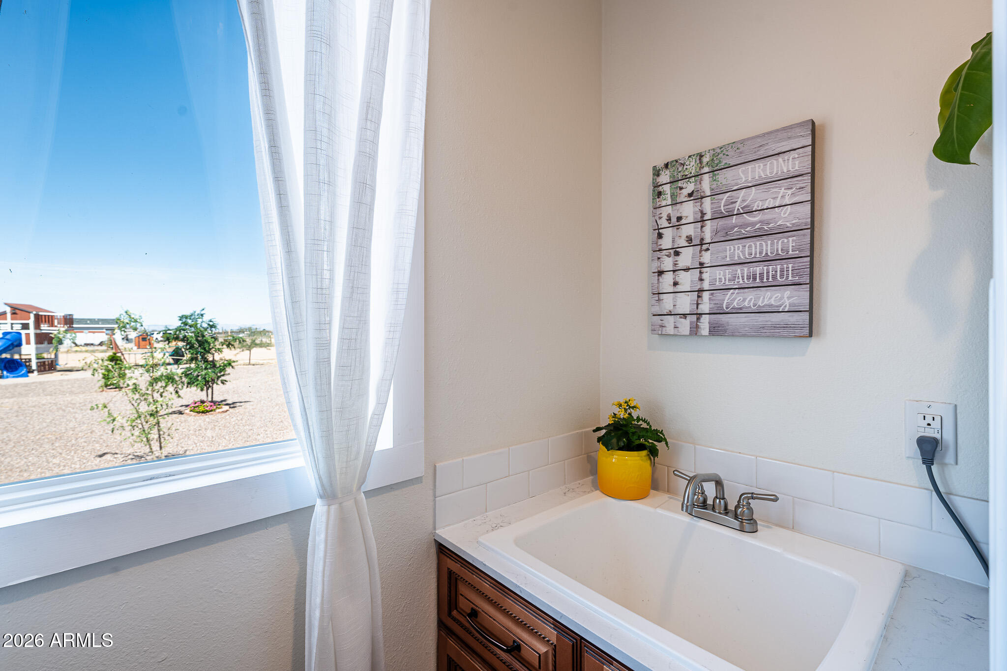 22622 East Day Spring Lane Florence, AZ 85132 - Photo 26 of 70 a bathroom with a sink a vanity and a window