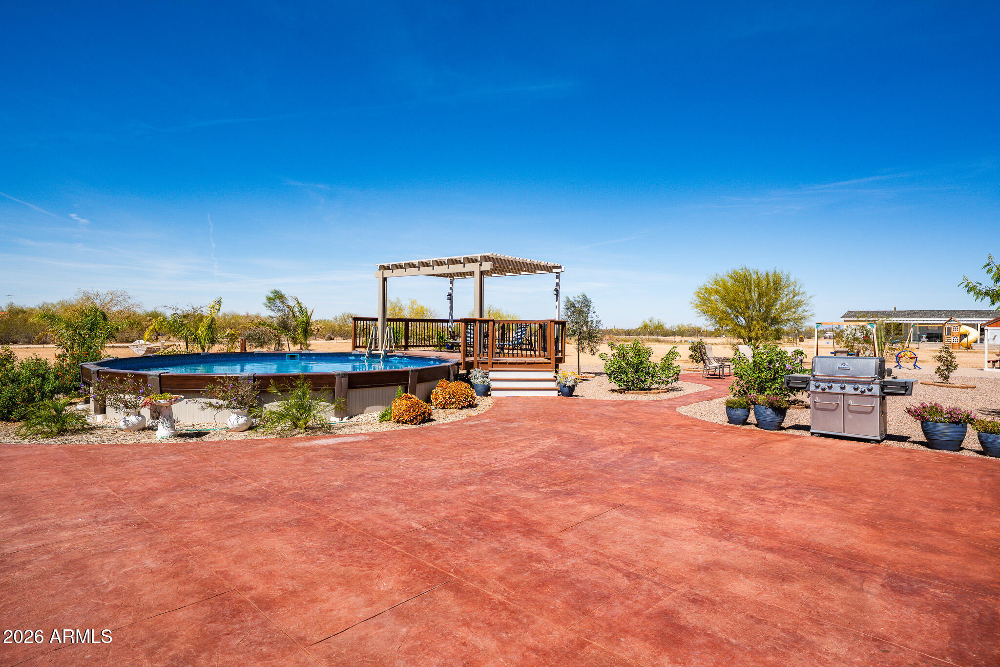 22622 East Day Spring Lane Florence, AZ 85132 - Photo 38 of 70 a view of a swimming pool with an outdoor seating and a yard