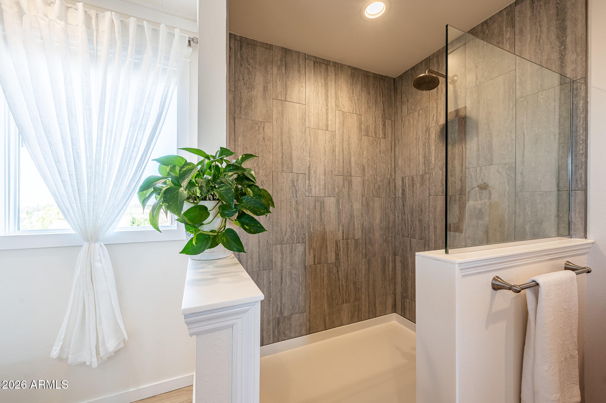 22622 East Day Spring Lane Florence, AZ 85132 - Photo 5 of 70 a bathroom with a shower curtain and a window