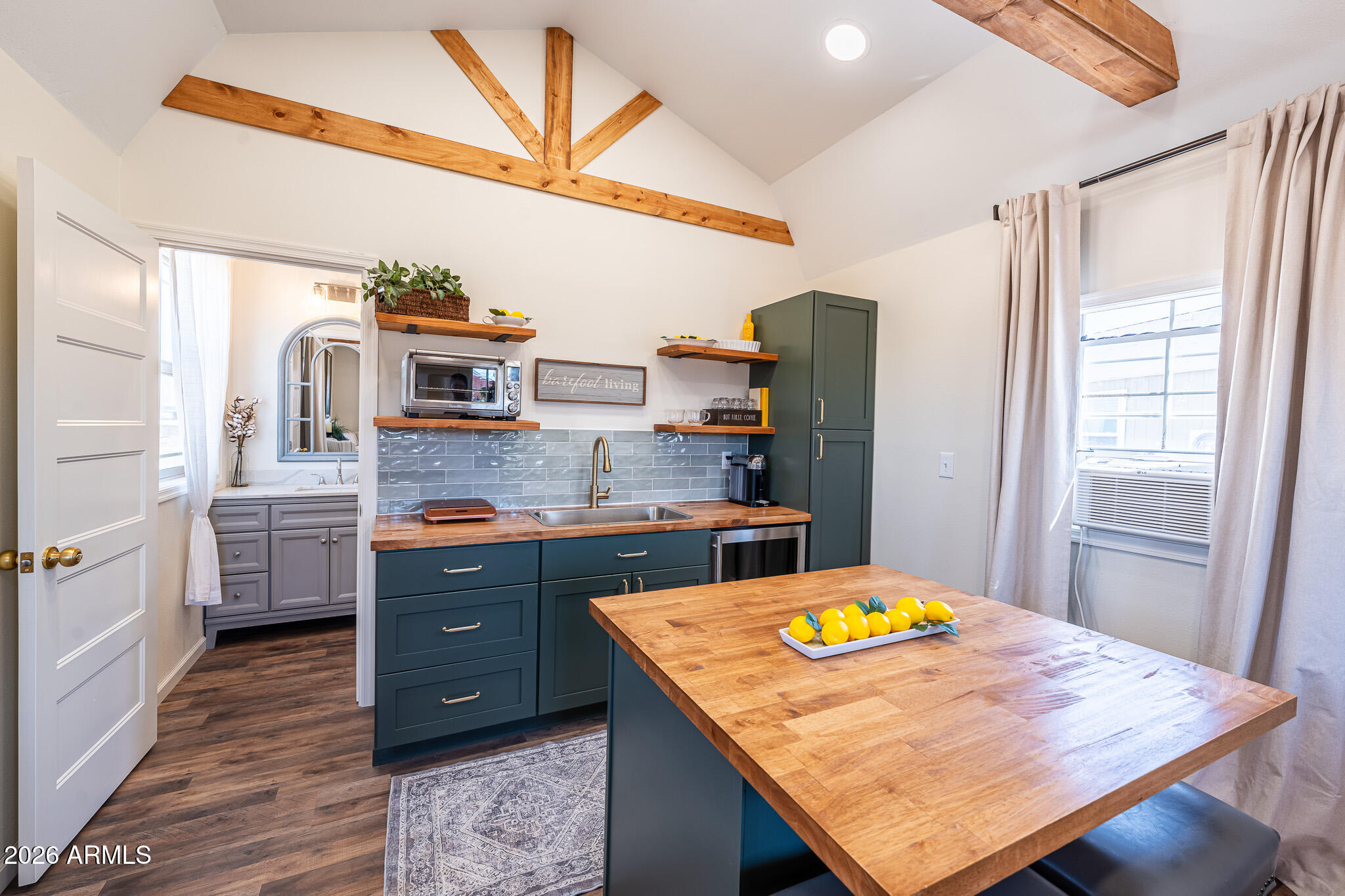 22622 East Day Spring Lane Florence, AZ 85132 - Photo 59 of 70 a kitchen with stainless steel appliances kitchen island granite countertop a table chairs in it and wooden floors
