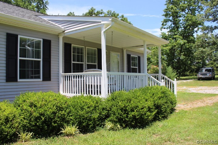 403 John Randolph Road Farmville, VA 23901 - Photo 16 of 23 a view of a house with a small yard and flower plants