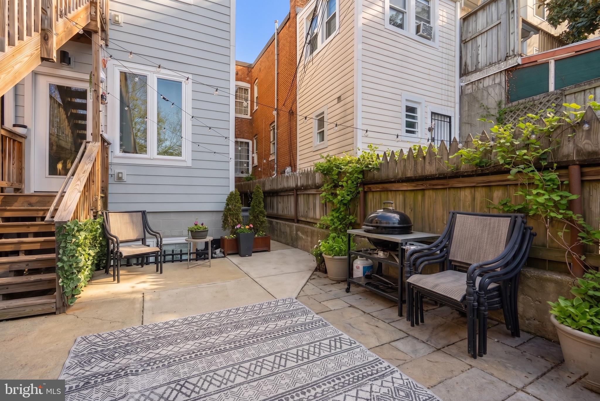 3572 13th Street Northwest, Unit 2 Washington, DC 20010 - Photo 22 of 26 a view of a patio with couches table and chairs and potted plants