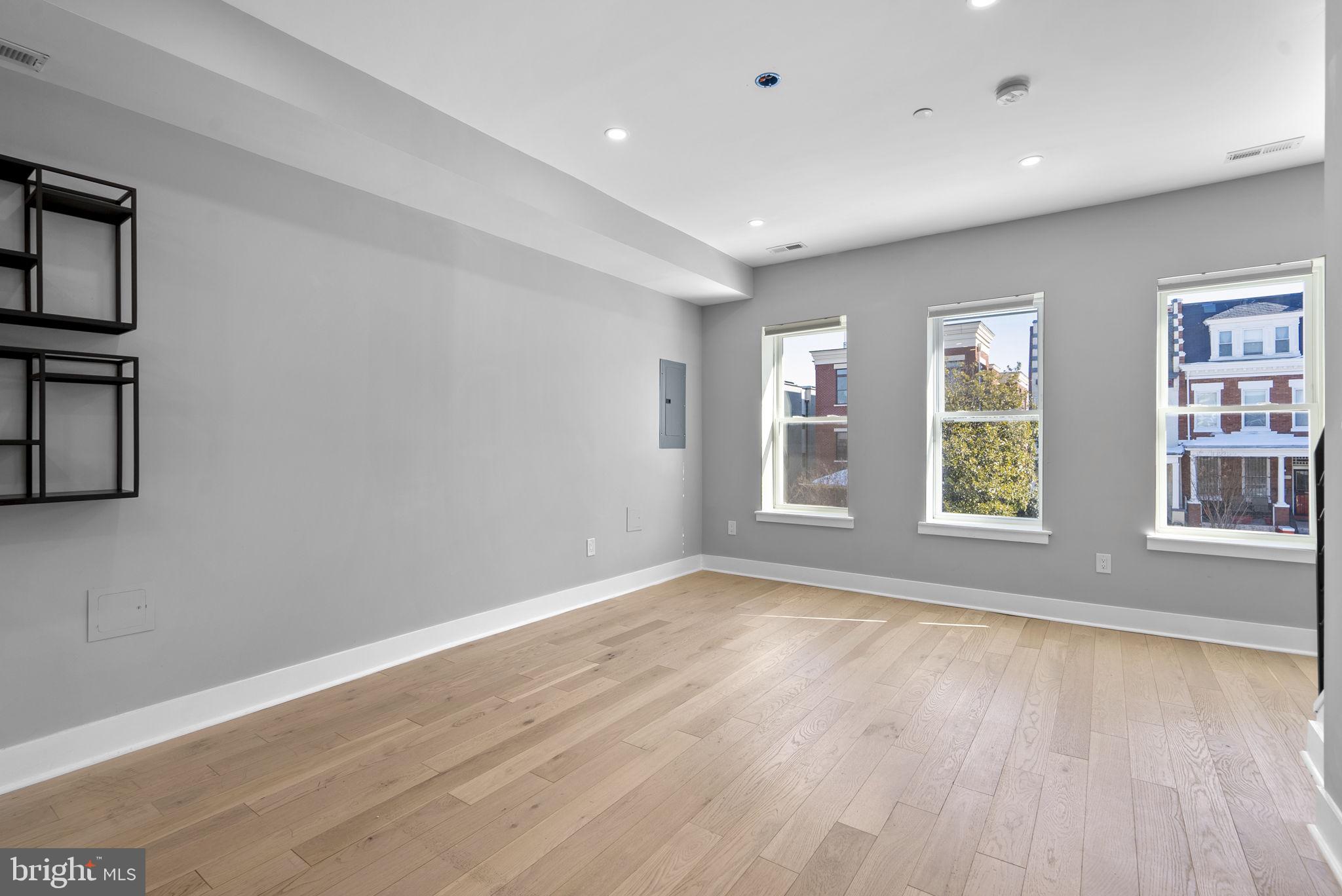 3572 13th Street Northwest, Unit 2 Washington, DC 20010 - Photo 7 of 26 a view of an empty room with a window and wooden floor