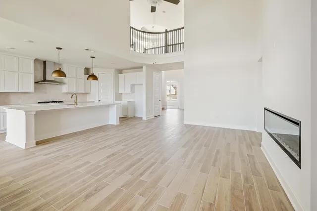 a view of a kitchen with wooden floor and a sink