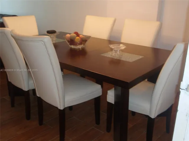 a view of a room with furniture and wooden floor