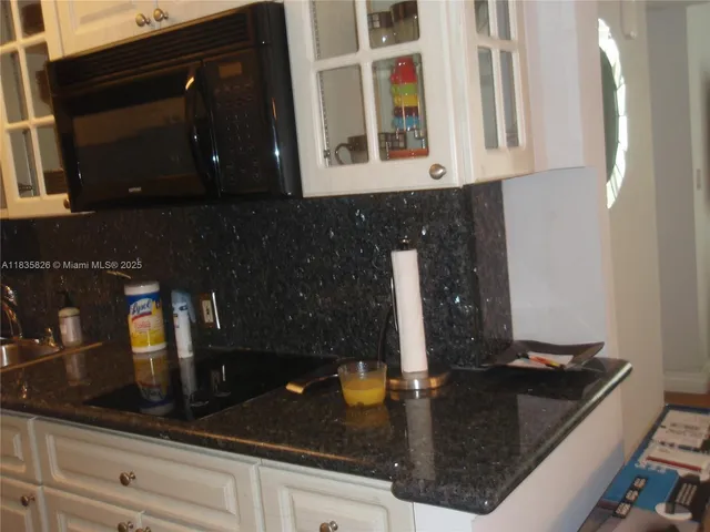 a kitchen with a refrigerator and cabinets