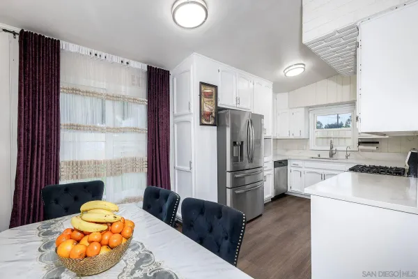 a kitchen with stainless steel appliances a refrigerator sink and cabinets