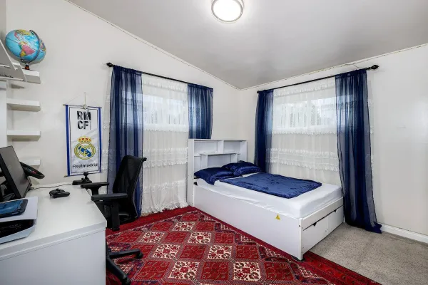 a living room with a bed furniture and a window