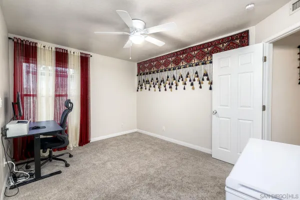a bedroom with a bed and a chair