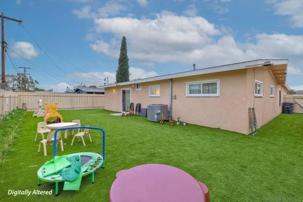 a backyard of a house with table and chairs