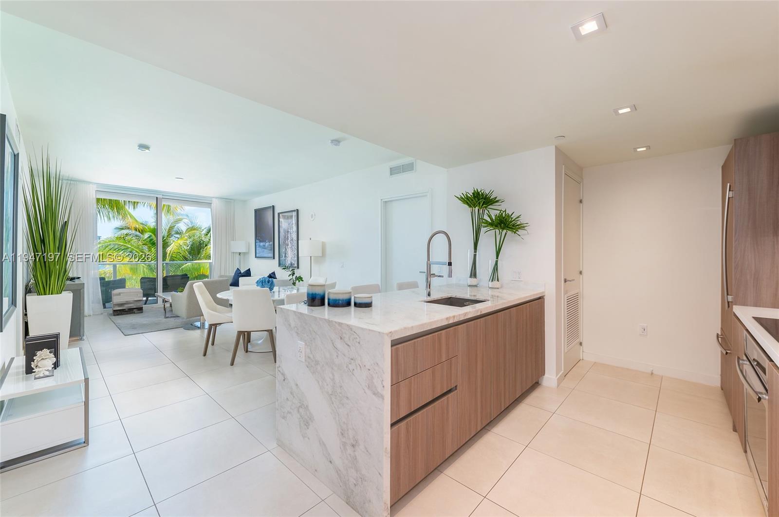 a view of living room kitchen with a stove top oven and potted plant