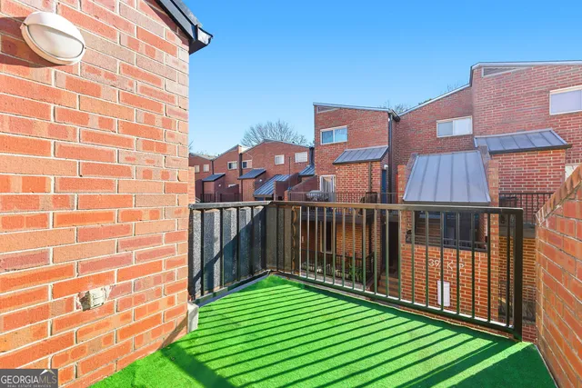 a view of a balcony with a yard