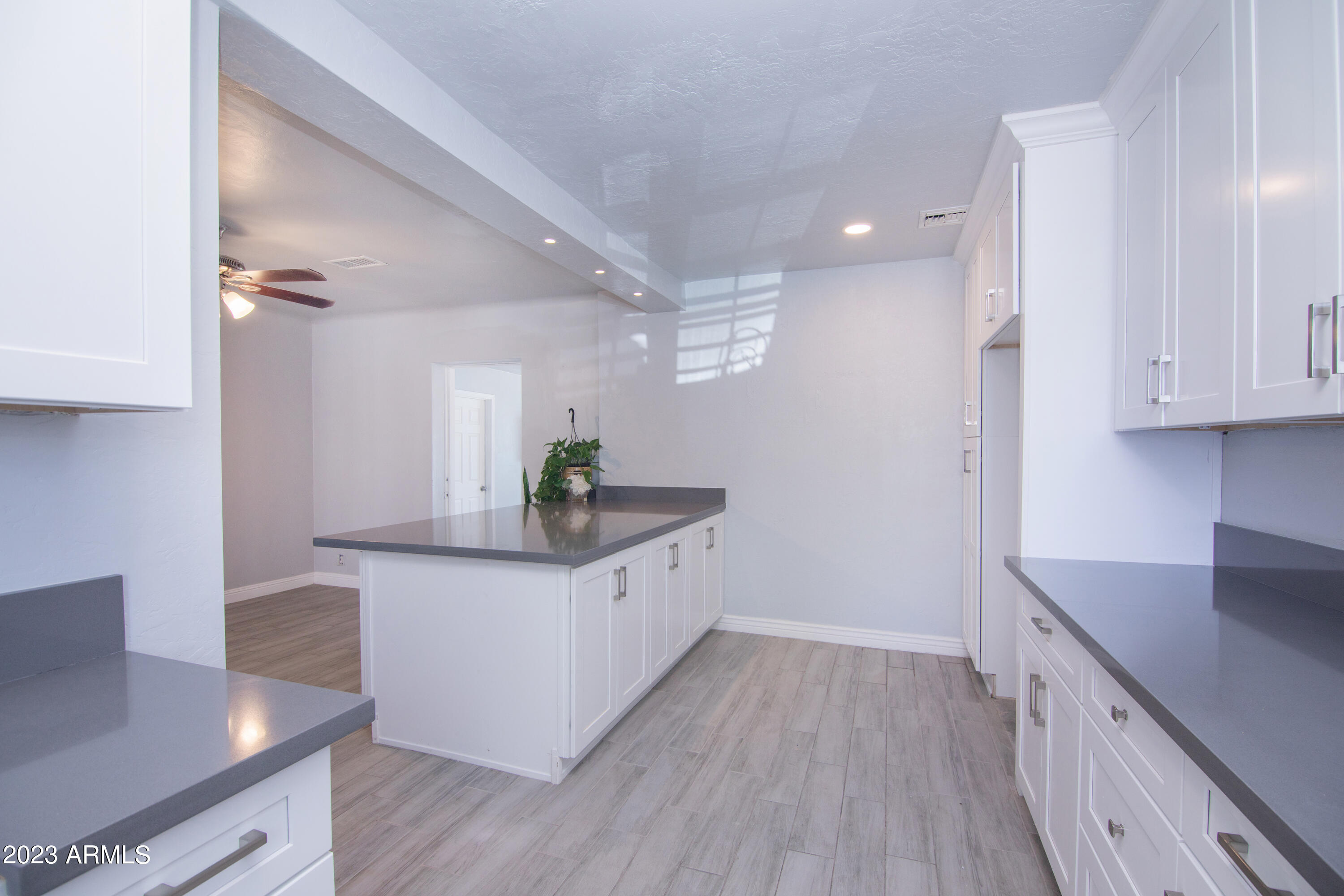 1318 East Granada Road Phoenix, AZ 85006 - Photo 18 of 38 a kitchen with granite countertop a white cabinets and window