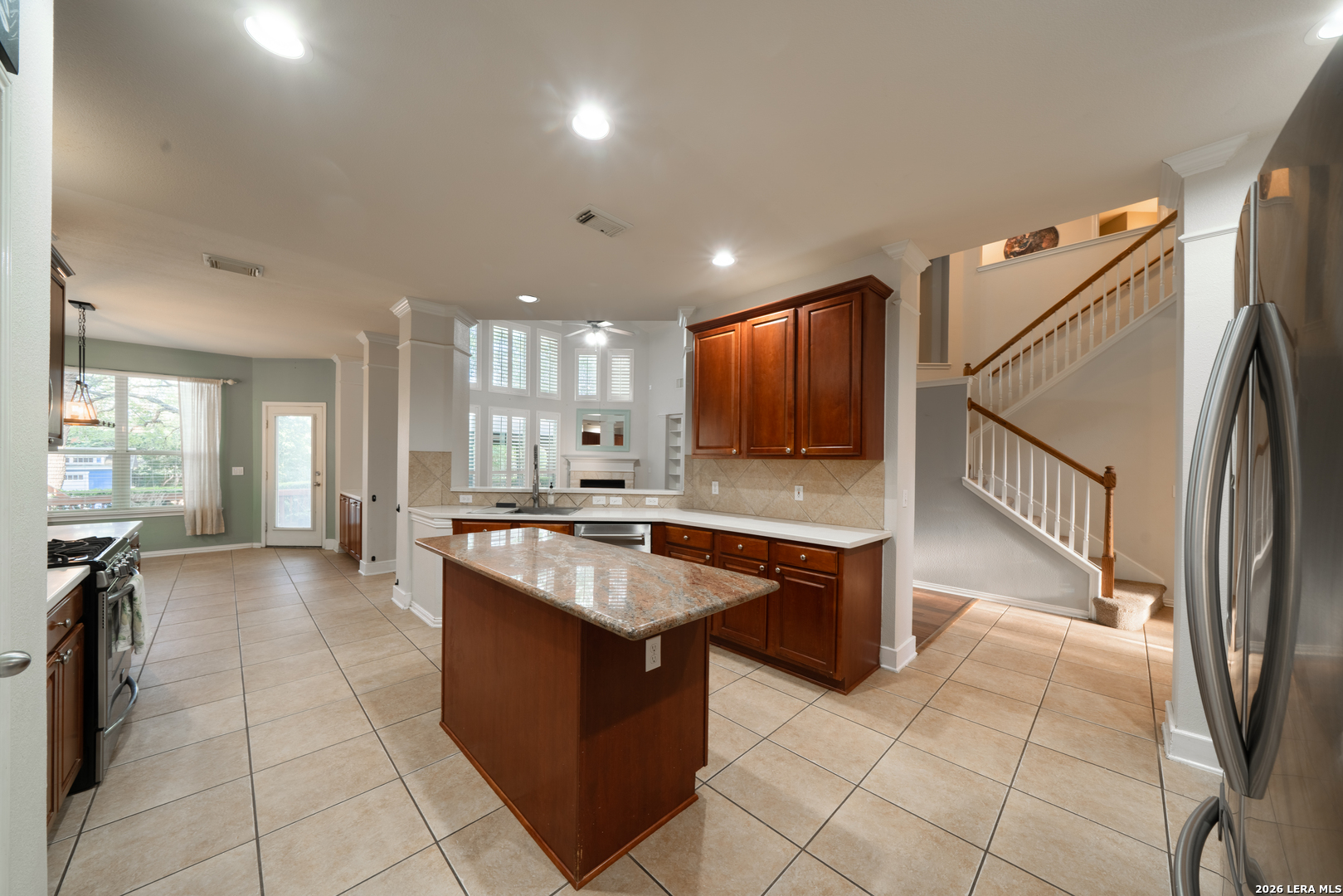 13034 Wild Heart Helotes, TX 78023 - Photo 12 of 49 a large kitchen with kitchen island a island a sink a stove and a center island