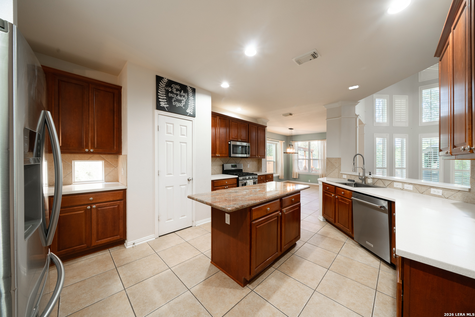13034 Wild Heart Helotes, TX 78023 - Photo 13 of 49 a kitchen with stainless steel appliances granite countertop a stove top oven and refrigerator