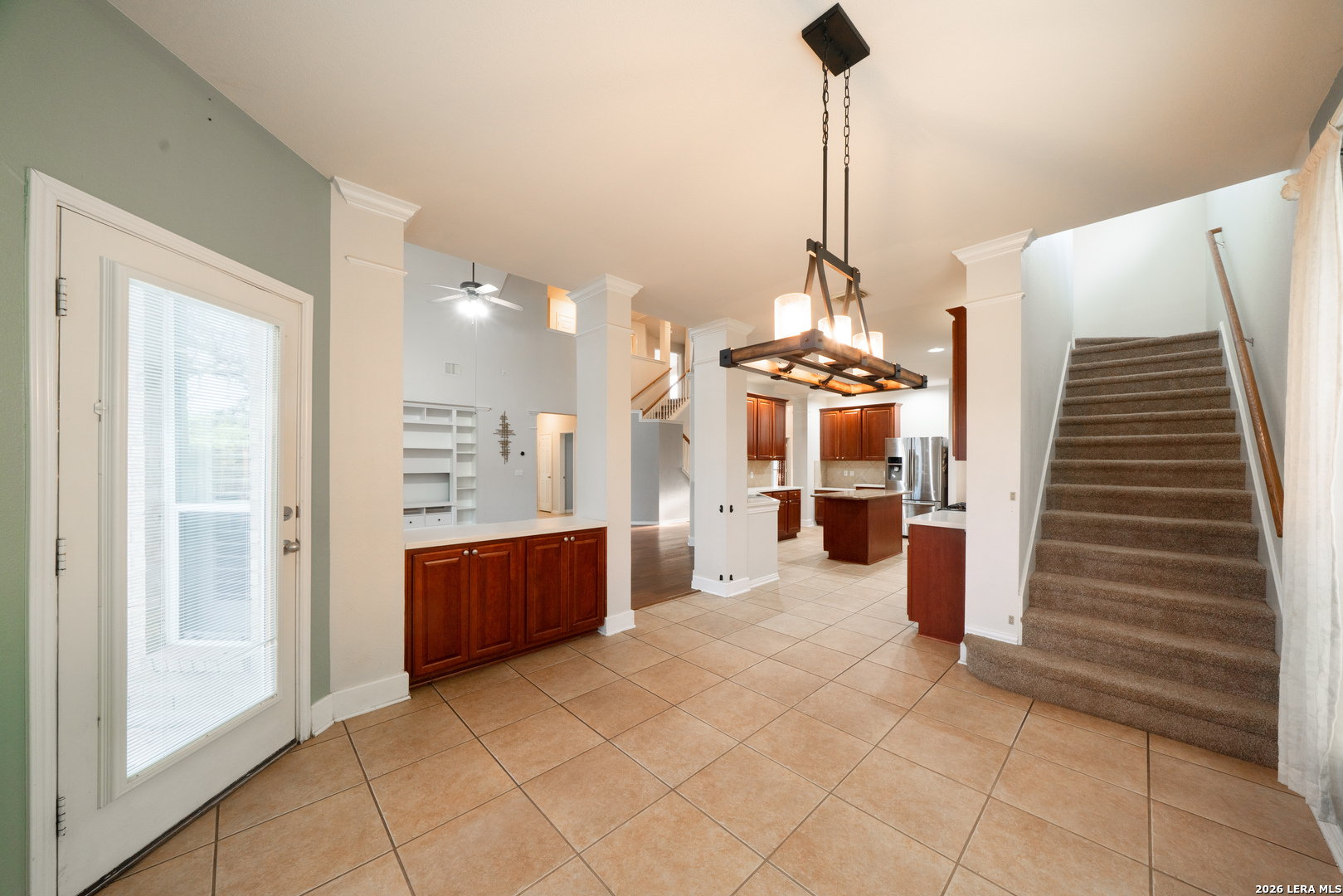 13034 Wild Heart Helotes, TX 78023 - Photo 15 of 49 a view of a hallway with entryway windows kitchen and a chandelier