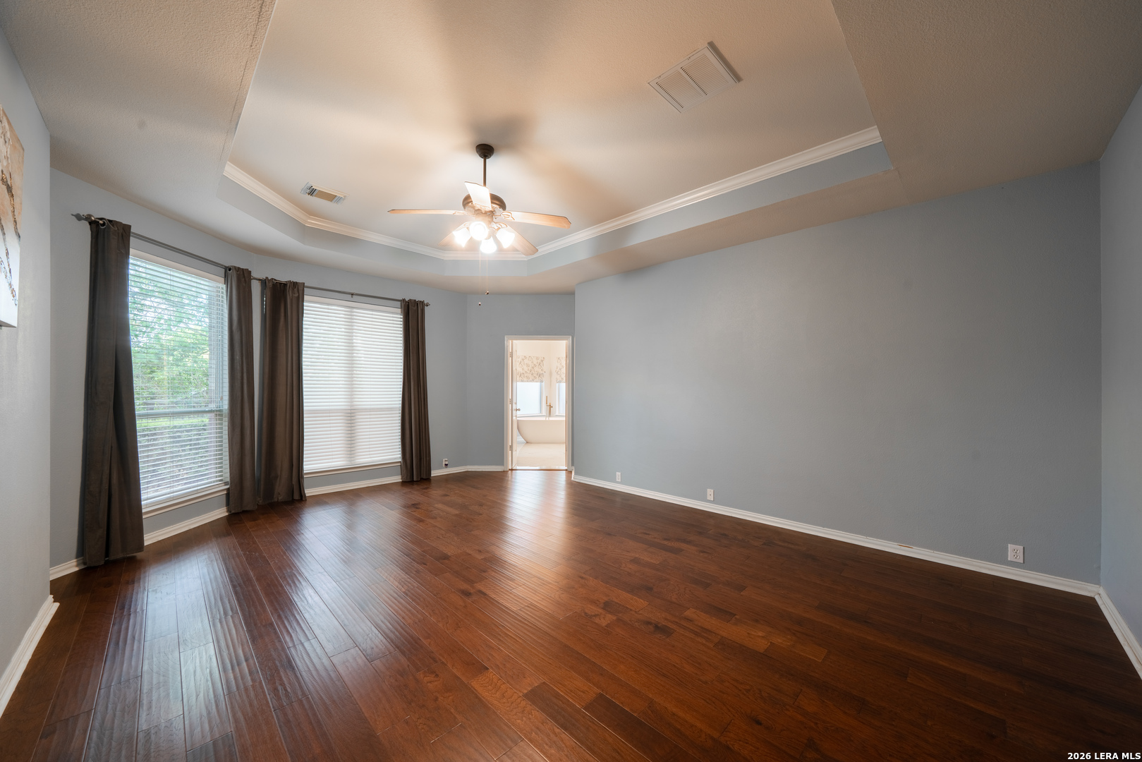 13034 Wild Heart Helotes, TX 78023 - Photo 20 of 49 a view of an empty room with wooden floor and a window