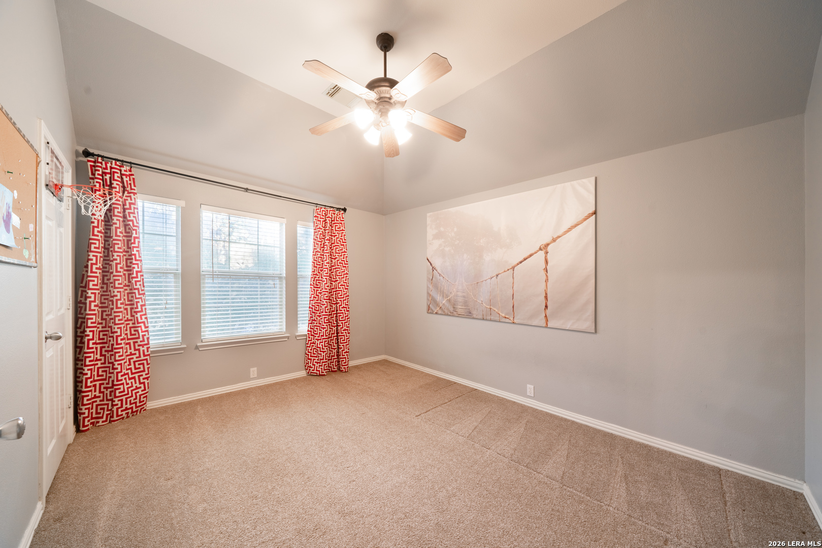 13034 Wild Heart Helotes, TX 78023 - Photo 28 of 49 an empty room with chandelier fan and windows