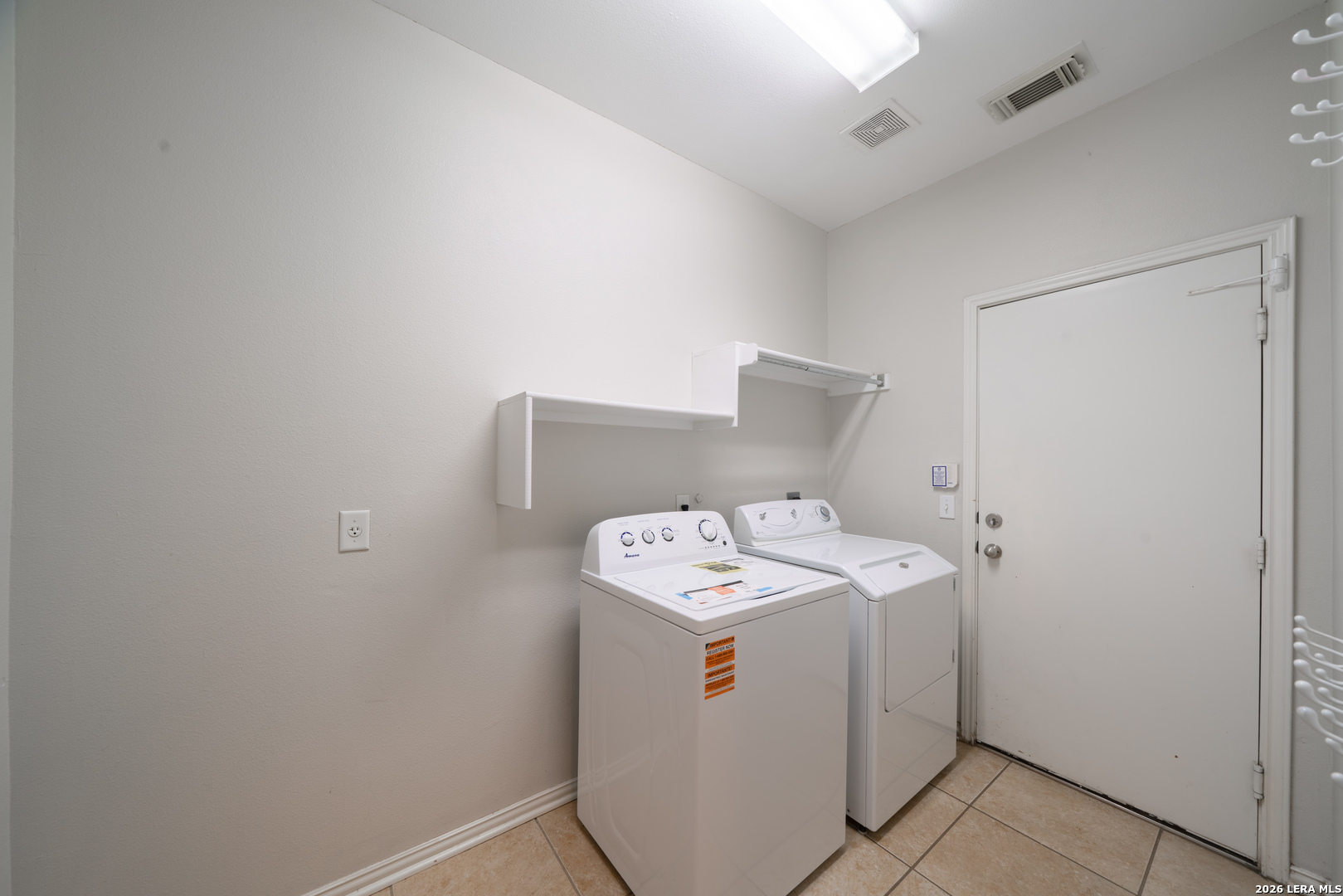 13034 Wild Heart Helotes, TX 78023 - Photo 35 of 49 a utility room with dryer and washer