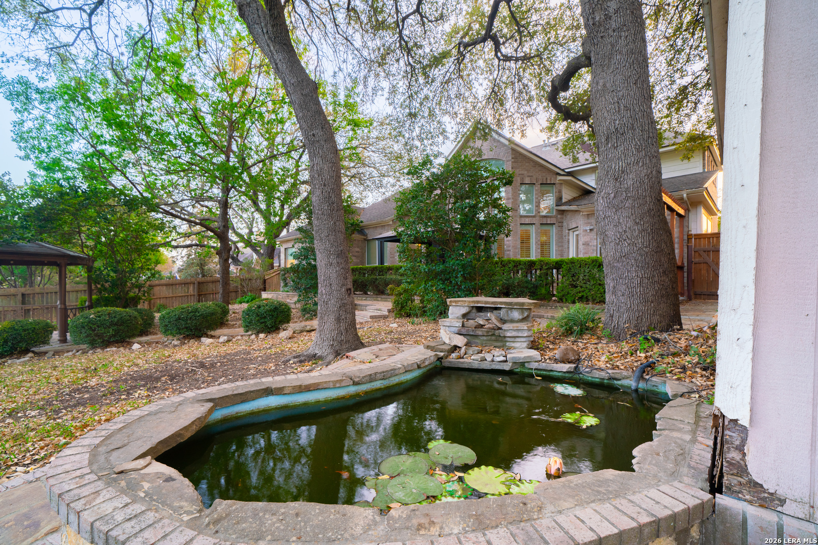 13034 Wild Heart Helotes, TX 78023 - Photo 40 of 49 a view of small pool with lawn chairs and plants