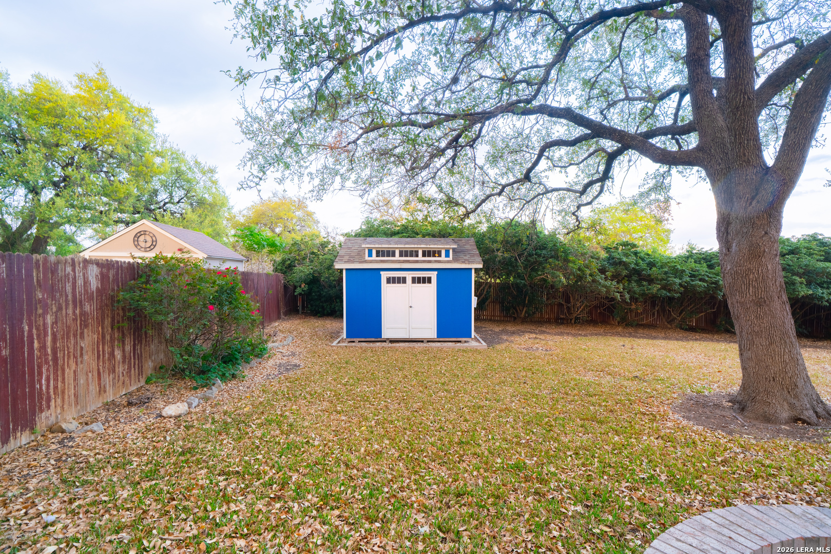13034 Wild Heart Helotes, TX 78023 - Photo 43 of 49 a big yard with large trees and wooden fence
