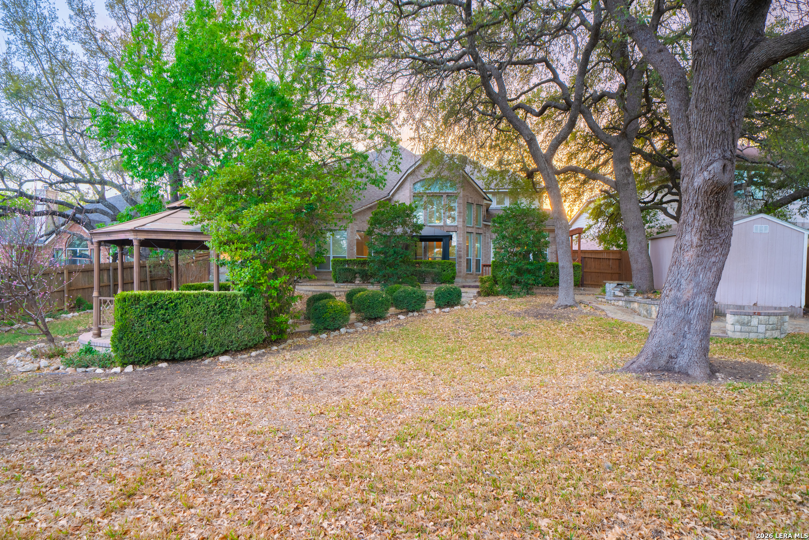 13034 Wild Heart Helotes, TX 78023 - Photo 44 of 49 a front view of a house with a yard and an tree