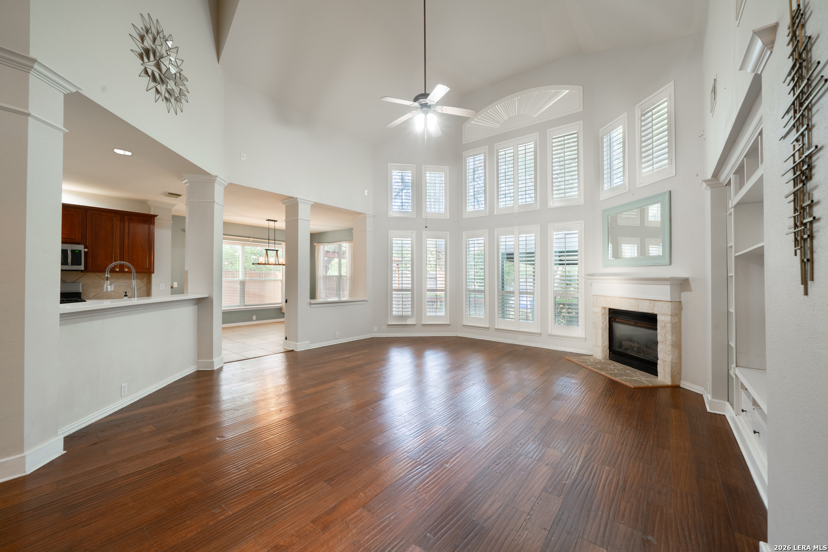 13034 Wild Heart Helotes, TX 78023 - Photo 10 of 49 a view of an empty room with wooden floor and a fireplace