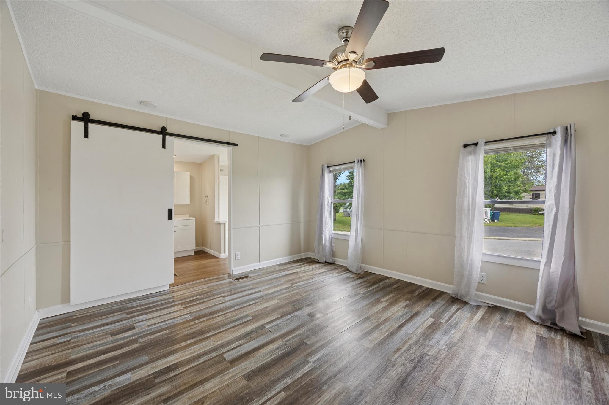 528 Vincent Lane, Unit 103 Bear, DE 19701 - Photo 8 of 16 Primary Bedroom with Barn Door into Bathroom