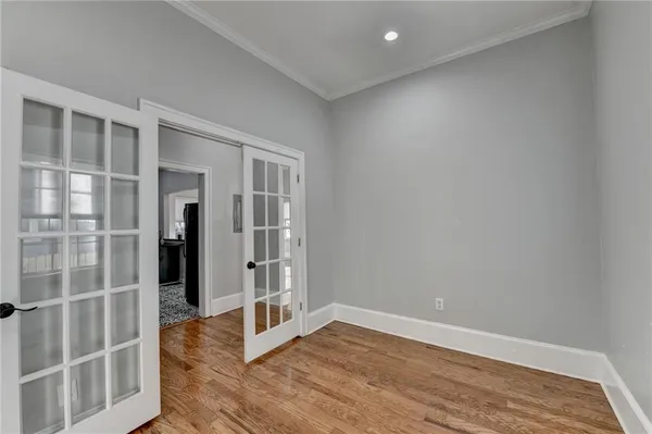 a view of wooden floor and windows in a room