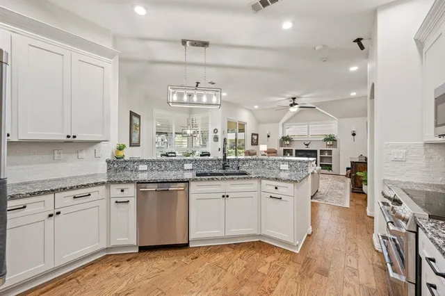 a large kitchen with cabinets a sink and a stove