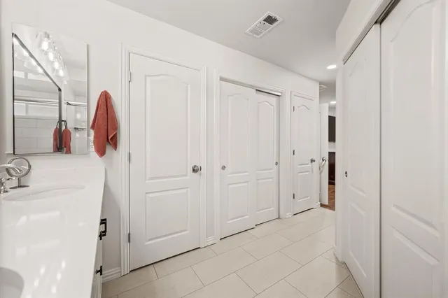 a bathroom with a sink vanity and mirror