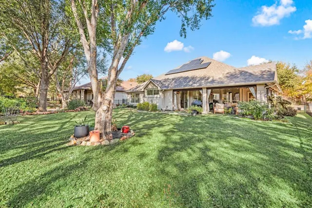 a front view of a house with a yard table and chairs