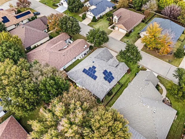 an aerial view of a house with a yard and garden