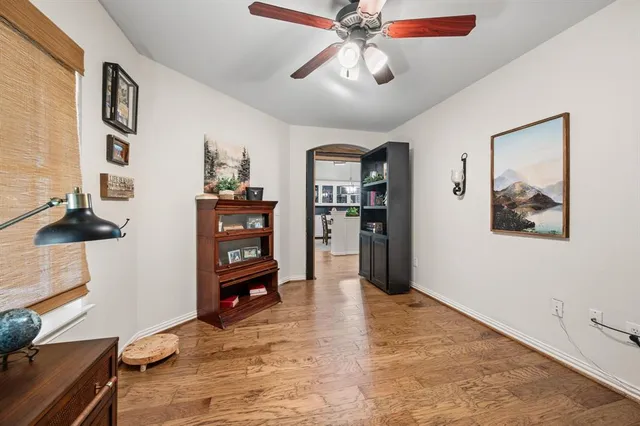 a view of a livingroom with a furniture wooden floor and a ceiling fan